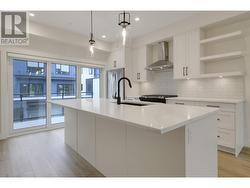 Galley style kitchen with oversized island with seating for 4 ppl and patio off of kitchen. -