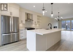 Galley style kitchen with oversized island with seating for 4 ppl and patio off of kitchen. -