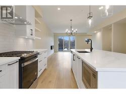 Galley style kitchen with oversized island with seating for 4 ppl and patio off of kitchen. -