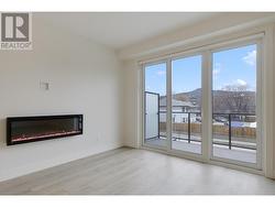 Living area with large patio sliding doors, electric fireplace and living area patio -