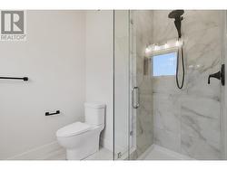 Primary ensuite with luxury shower tiled to the roof and rain showerhead -