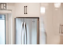 Whirlpool stainless steel fridge with double doors and freezer on bottom -