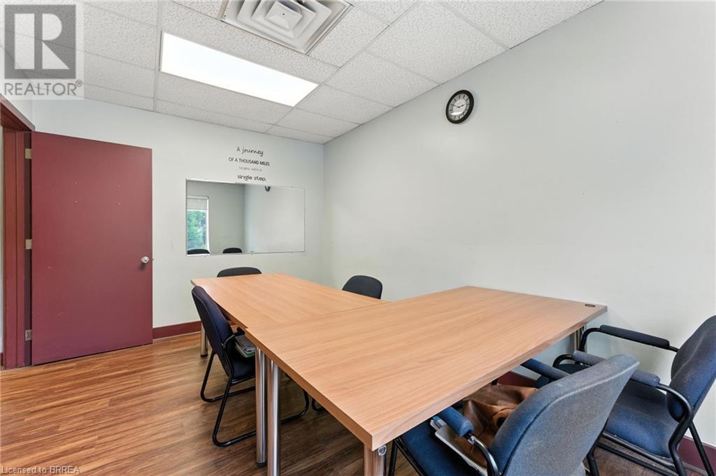 Office featuring wood finished floors and a paneled ceiling - 207 Greenwich Street, Brantford, ON
