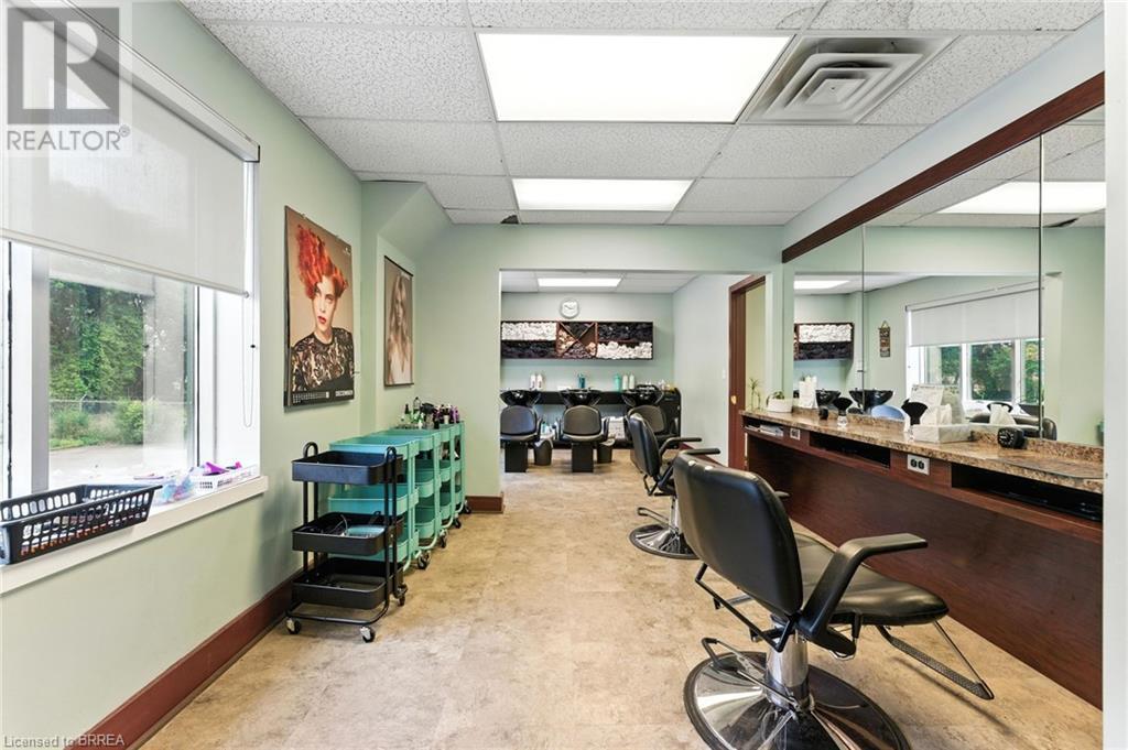 Office space featuring a drop ceiling and baseboards - 207 Greenwich Street, Brantford, ON