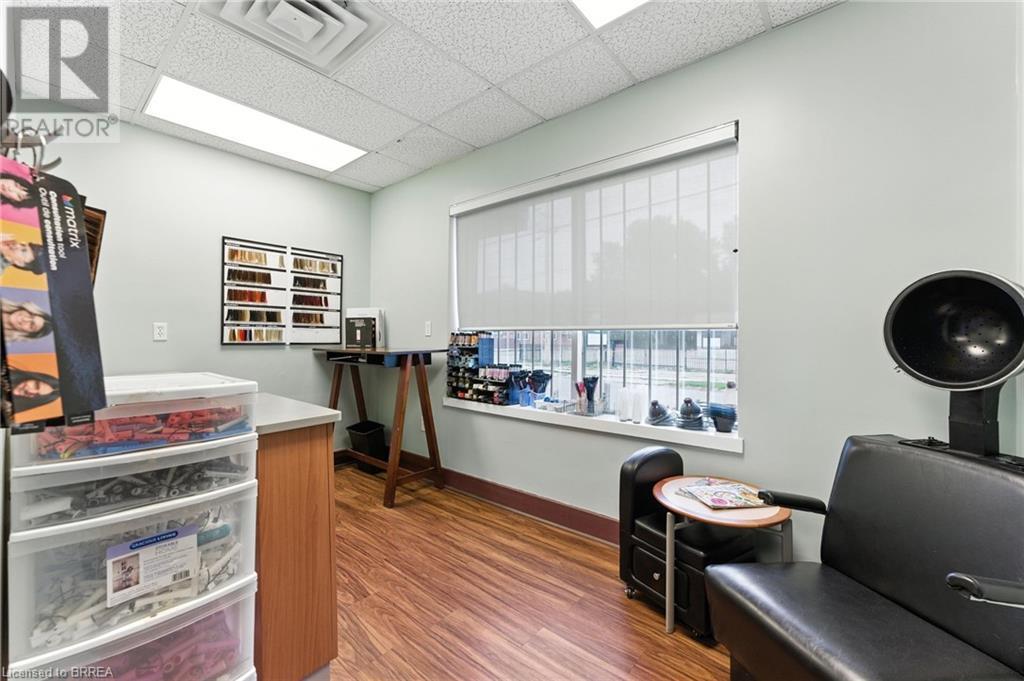 Office space featuring a drop ceiling and wood finished floors - 207 Greenwich Street, Brantford, ON