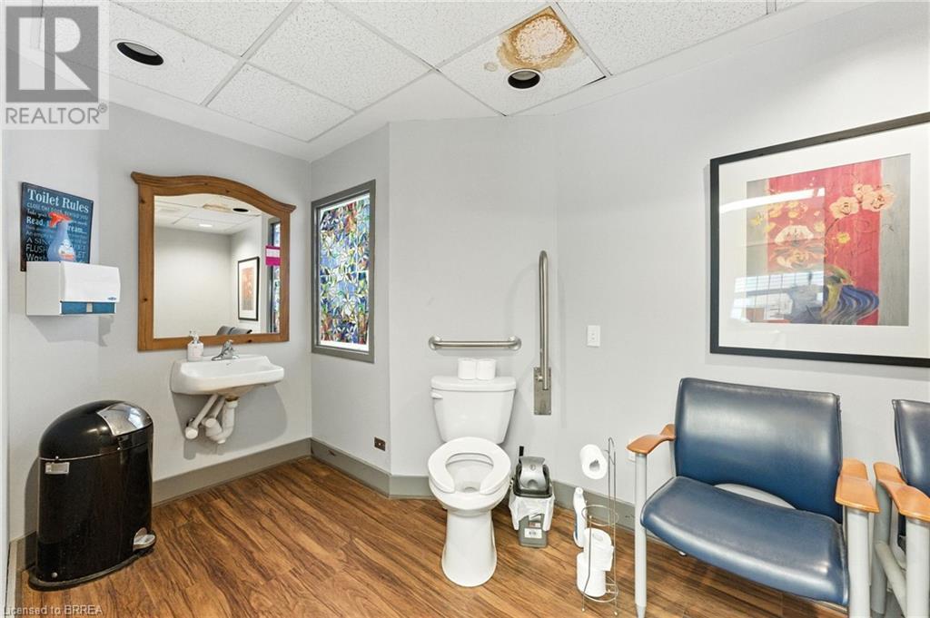 Bathroom with a drop ceiling and wood finished floors - 207 Greenwich Street, Brantford, ON