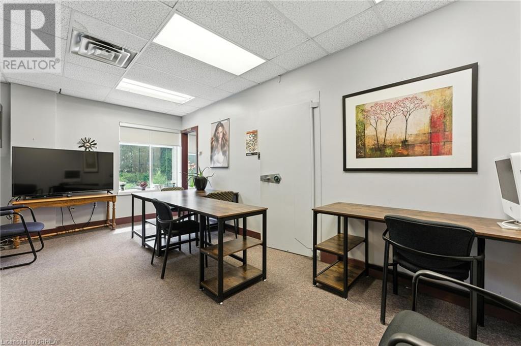 Carpeted office space featuring a paneled ceiling - 207 Greenwich Street, Brantford, ON