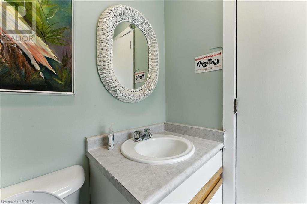Half bathroom with vanity and toilet - 207 Greenwich Street, Brantford, ON
