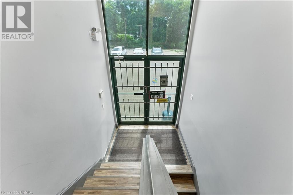 Stairway featuring french doors and baseboards - 207 Greenwich Street, Brantford, ON