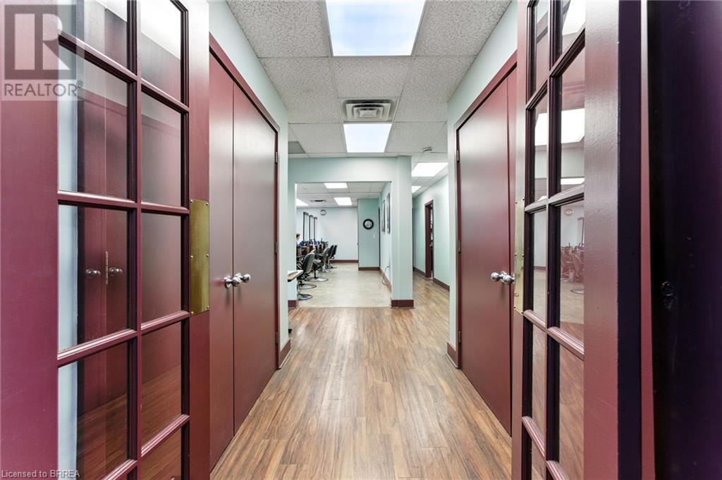 Hall featuring a paneled ceiling and wood finished floors - 207 Greenwich Street, Brantford, ON