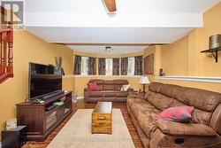 Family Room with ceiling fan and large windows -