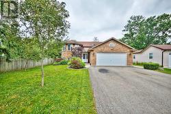 Landscaped front yard, driveway and garage -
