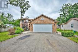 Front of the property with double garage & shrubs -