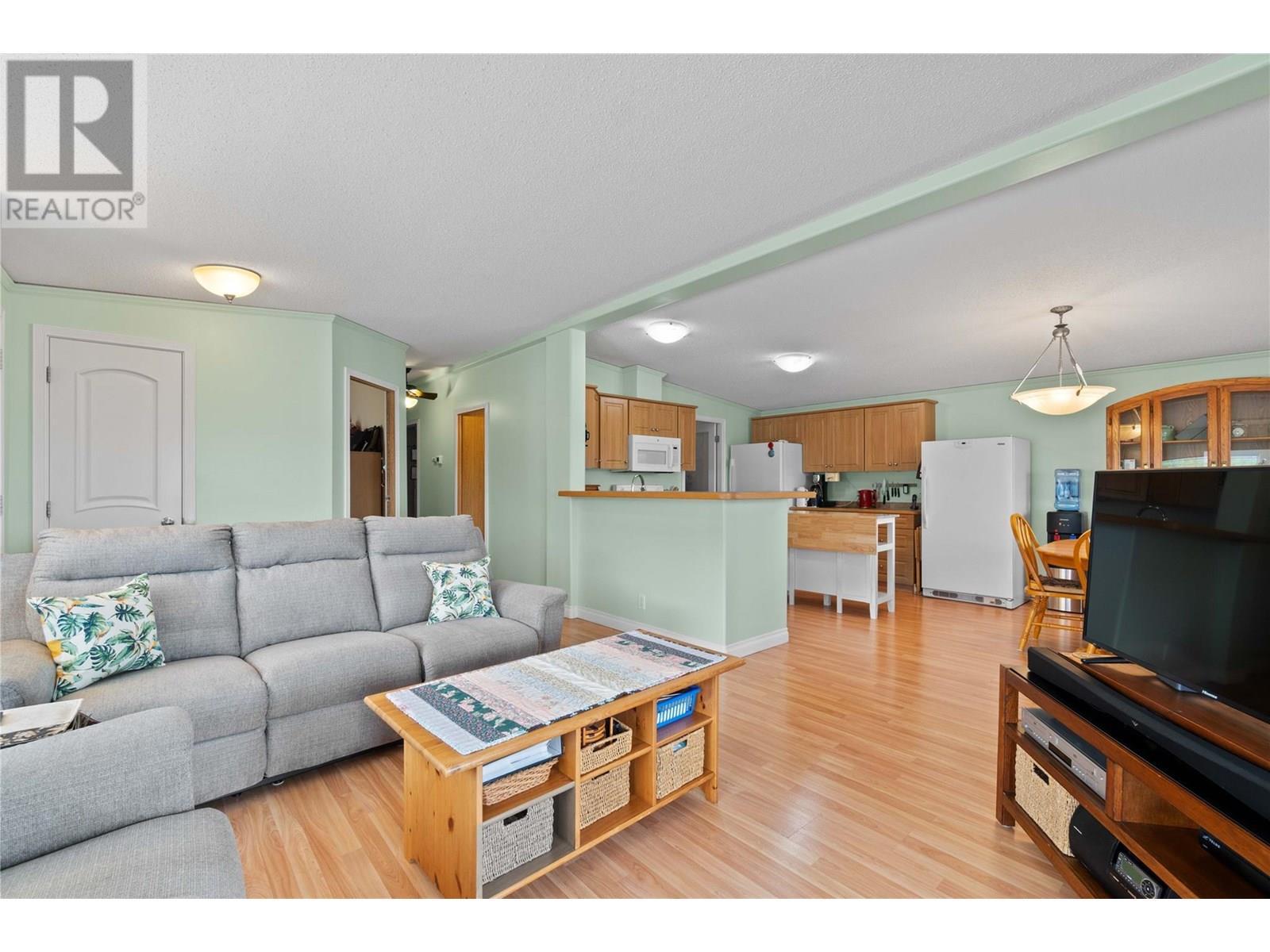 Living room to kitchen - 1885 Tappen Notch Hill Road Unit# 48, Tappen, BC