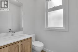 Main floor powder room - Photo of a similar home in the community. -