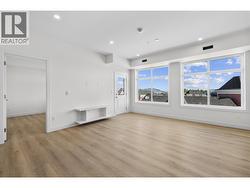 Large windows in the living area let in ample natural light. -