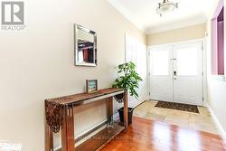 Entrance foyer featuring ornamental molding and light hardwood / wood-style flooring -