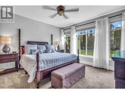 Primary Bedroom, Main Level with large windows onto the backyard. 16x14 -