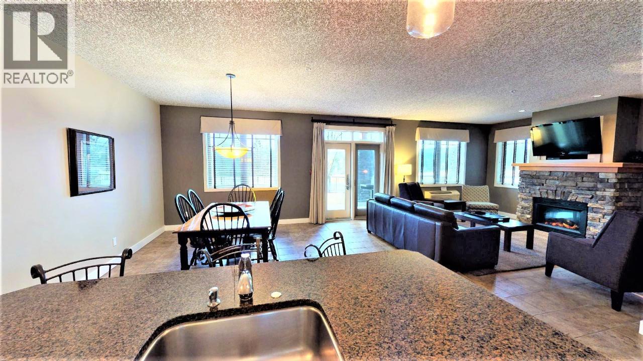 400 Bighorn Boulevard Unit# 416 F, Radium Hot Springs, BC - Indoor Photo Showing Living Room With Fireplace