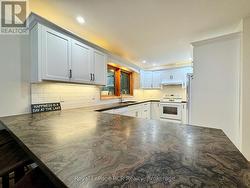 Custom cabinetry & polished stone counters. -