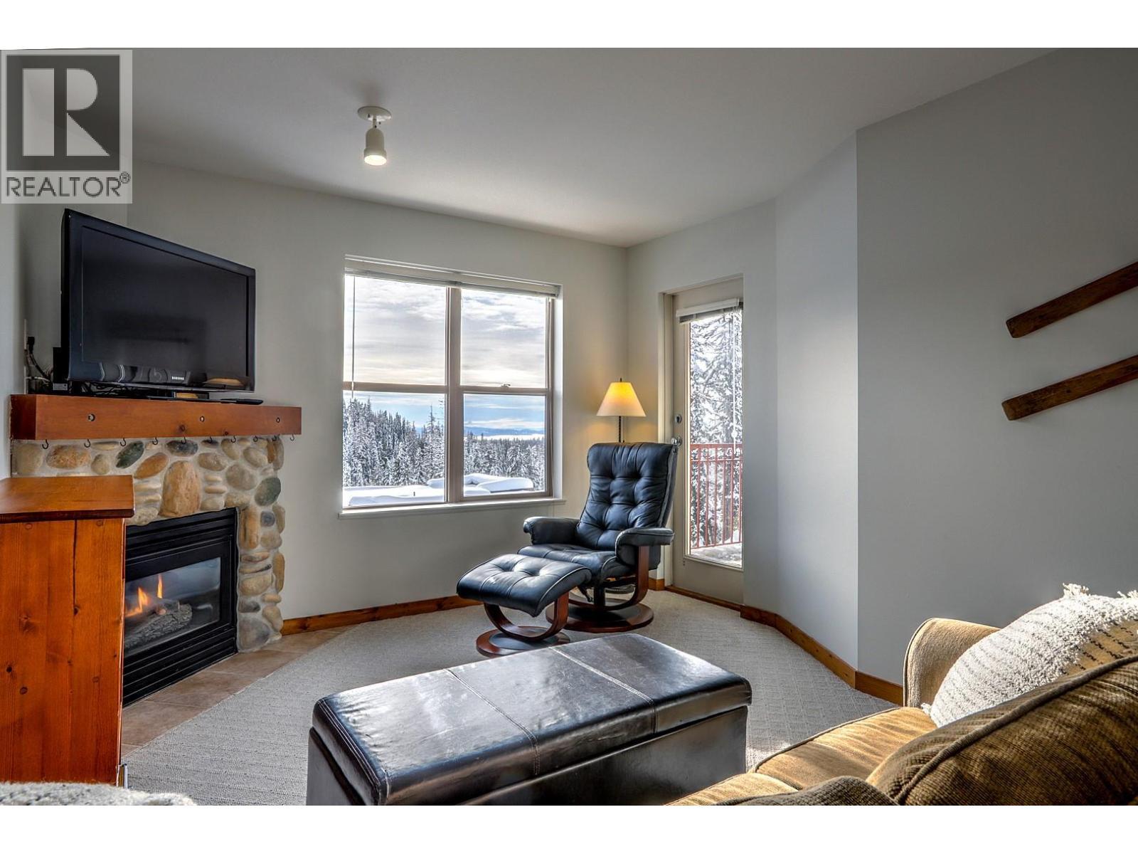 9802 Silver Star Road Unit# 306, Silver Star, BC - Indoor Photo Showing Living Room With Fireplace