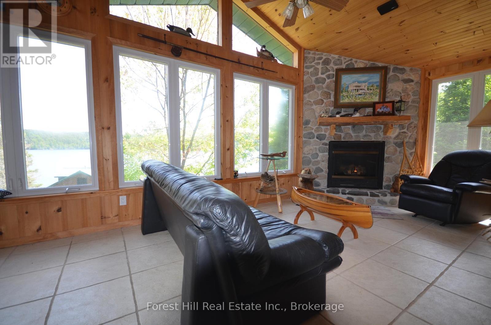 Main house living room - 10365 Rabbit, Temagami, ON - Indoor Photo Showing Living Room With Fireplace