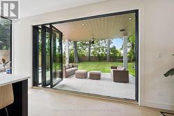 Accordian Glass Doors Open to a Covered Terrace -