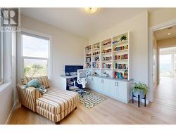 Main floor dedicated office space with built in desk and shelving -