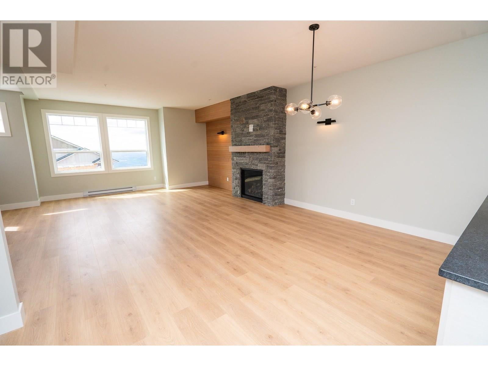 270A Grizzly Ridge Trail, Big White, BC - Indoor Photo Showing Living Room With Fireplace