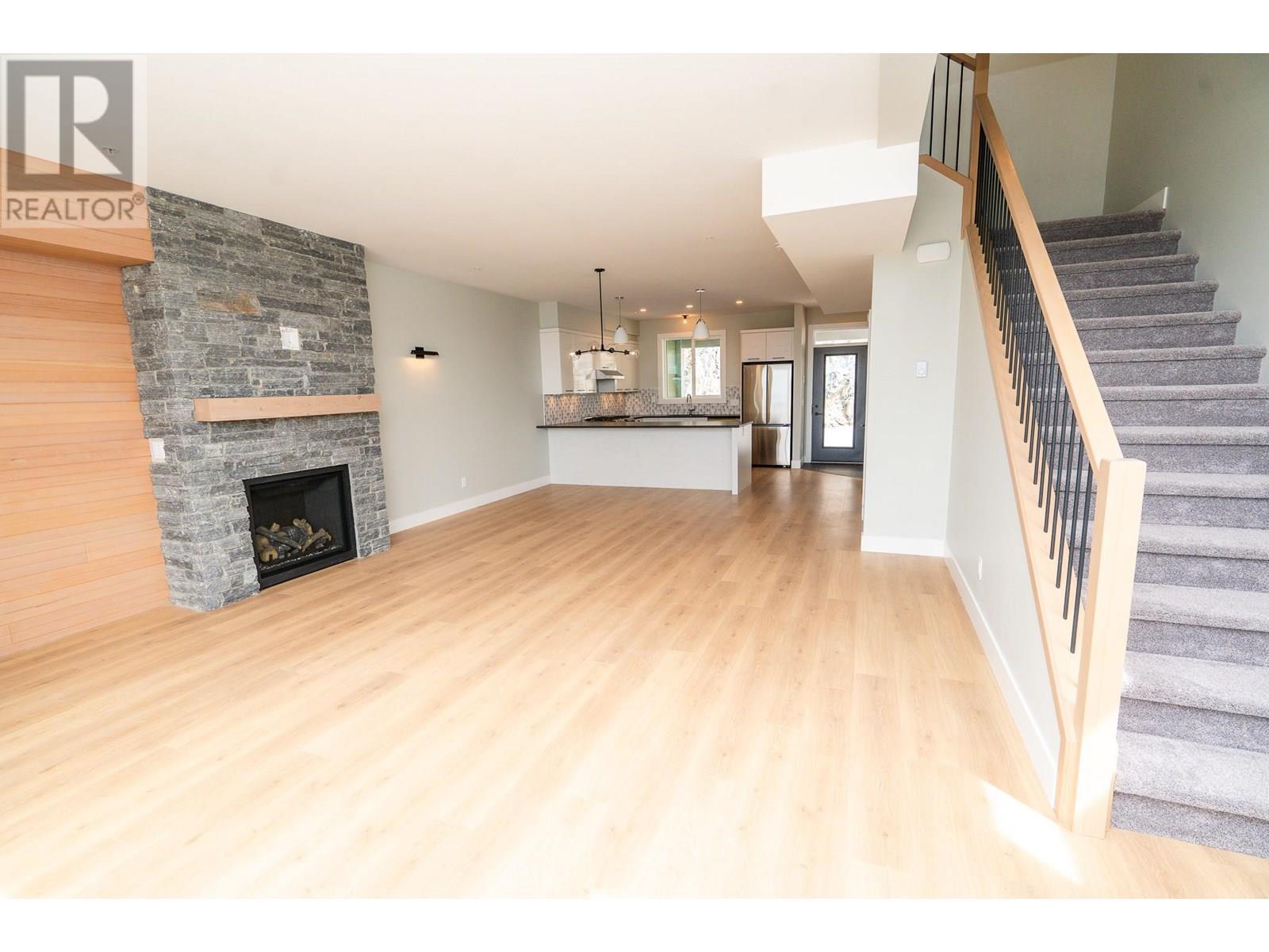 270A Grizzly Ridge Trail, Big White, BC - Indoor Photo Showing Living Room With Fireplace