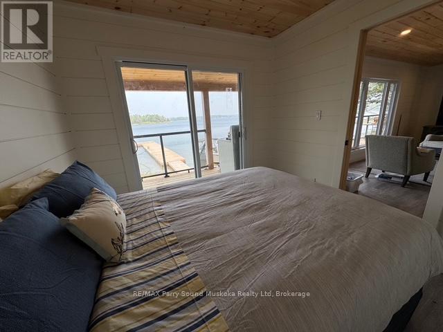Primary Bedroom w. Walkout to covered porch - 1370 Georgian Bay Water, The Archipelago (Archipelago North), ON - Indoor Photo Showing Bedroom
