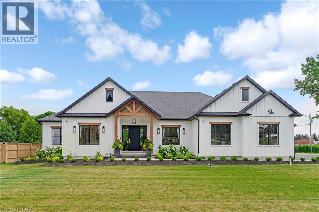 Modern inspired farmhouse featuring a shingled roof and board and batten siding - 4678 Lobsinger Line, Crosshill, ON - Outdoor With Facade