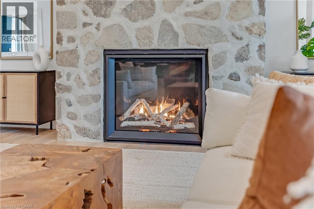 Detailed view of a fireplace and wood finished floors - 4678 Lobsinger Line, Crosshill, ON - Indoor Photo Showing Living Room With Fireplace