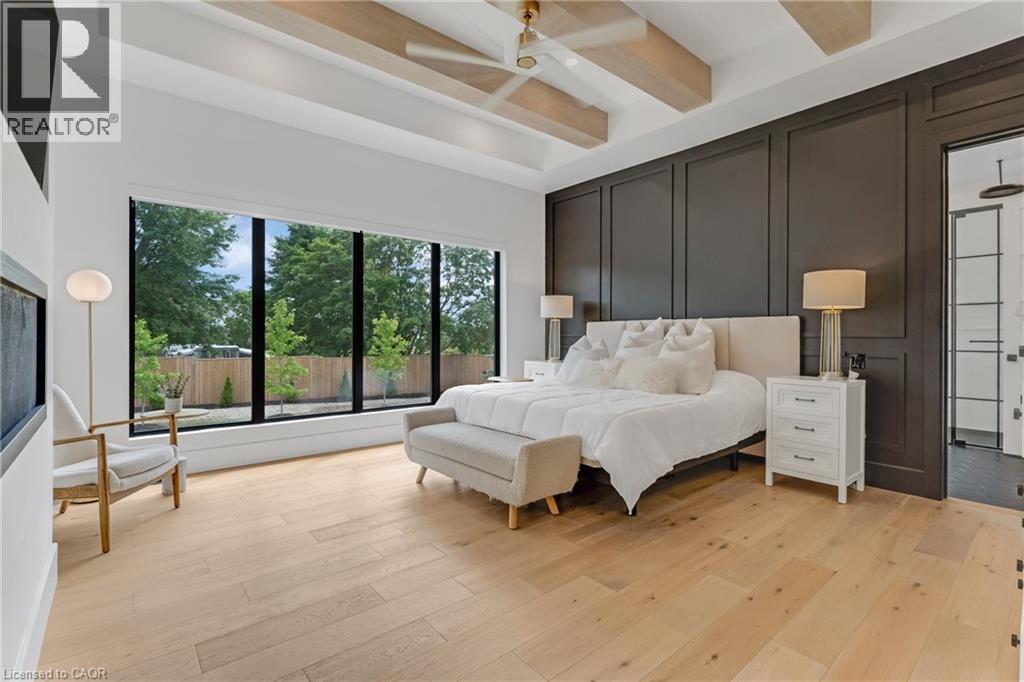 Bedroom featuring beamed ceiling, light wood-type flooring, and a ceiling fan - 4678 Lobsinger Line, Crosshill, ON - Indoor Photo Showing Bedroom