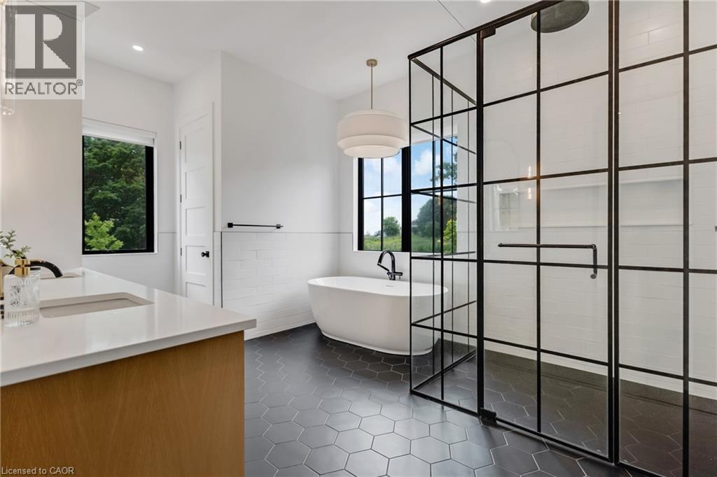 Full bathroom featuring tile patterned flooring, vanity, a soaking tub, a stall shower, and tile walls - 4678 Lobsinger Line, Crosshill, ON - Indoor Photo Showing Other Room