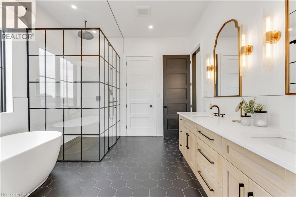Full bath featuring a shower stall, a soaking tub, double vanity, recessed lighting, and tile patterned flooring - 4678 Lobsinger Line, Crosshill, ON - Indoor Photo Showing Bathroom