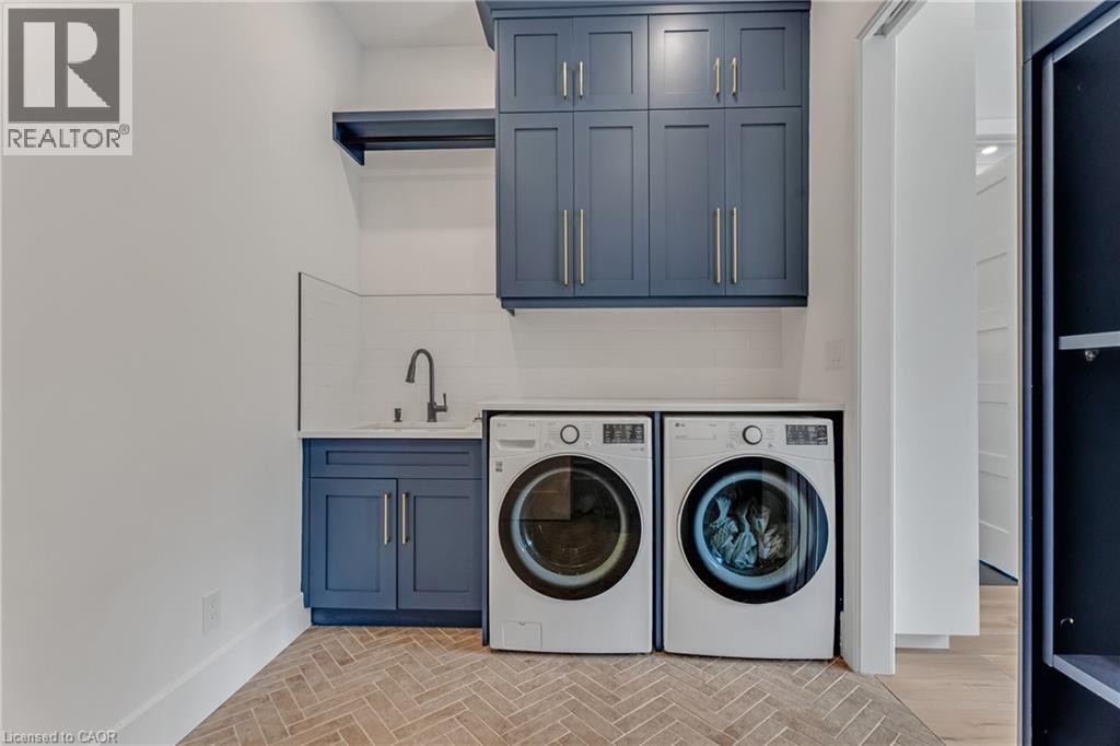 Washroom featuring cabinet space and washing machine and clothes dryer - 4678 Lobsinger Line, Crosshill, ON - Indoor Photo Showing Laundry Room