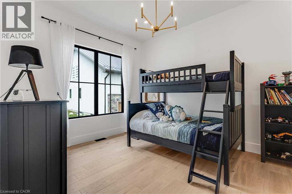 Bedroom featuring a chandelier and light wood-style floors - 4678 Lobsinger Line, Crosshill, ON - Indoor Photo Showing Bedroom