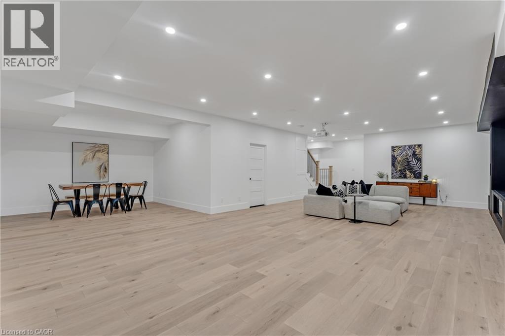 Living room with stairway, light wood-style flooring, and recessed lighting - 4678 Lobsinger Line, Crosshill, ON - Indoor