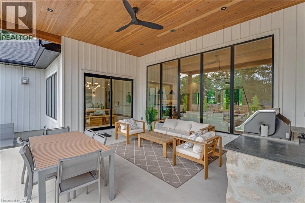View of patio / terrace with ceiling fan, an outdoor hangout area, an outdoor kitchen, and outdoor dining space - 4678 Lobsinger Line, Crosshill, ON - Outdoor With Deck Patio Veranda With Exterior