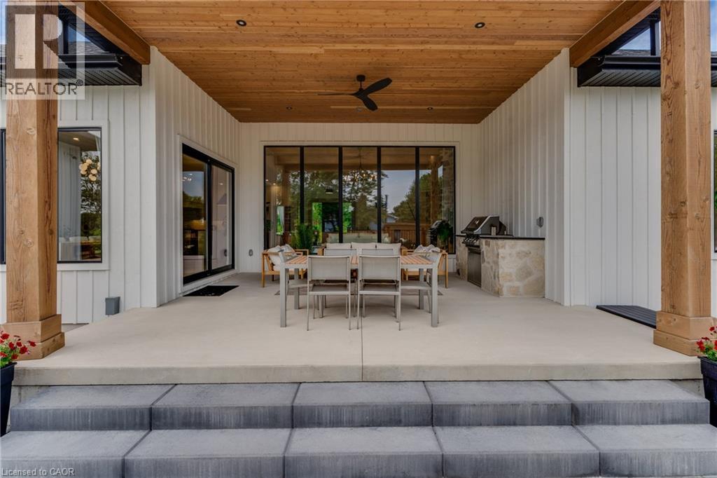 View of patio with outdoor dining space, a ceiling fan, and exterior kitchen - 4678 Lobsinger Line, Crosshill, ON - With Exterior