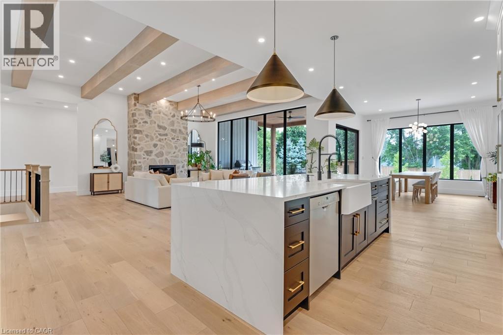 Kitchen with dishwasher, light wood-style floors, healthy amount of natural light, a chandelier, and recessed lighting - 4678 Lobsinger Line, Crosshill, ON - Indoor Photo Showing Kitchen With Upgraded Kitchen