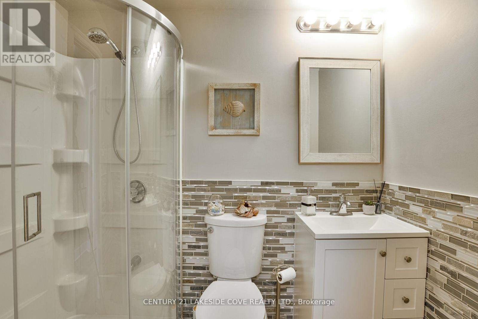 His / Hers Bathrooms - Unit 14 - 1 Paradise Boulevard, Ramara, ON - Indoor Photo Showing Bathroom