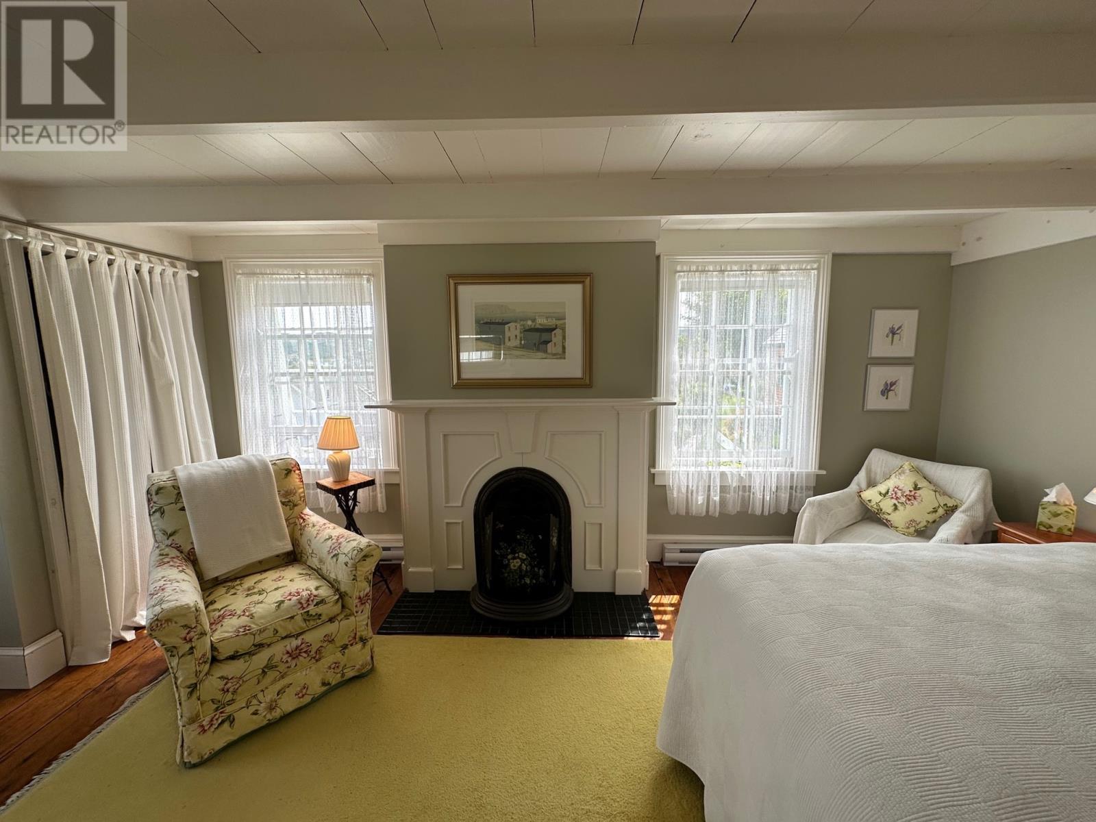 19 West Street, Trinity, NL - Indoor Photo Showing Bedroom With Fireplace
