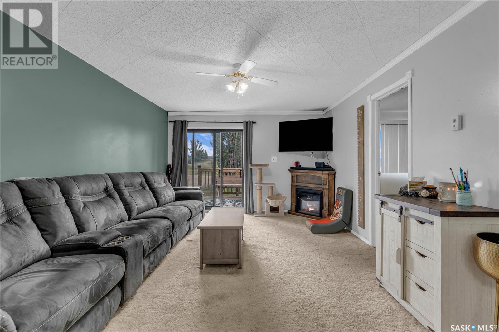 104 Railway Avenue, Dufferin Rm No. 190, SK - Indoor Photo Showing Living Room With Fireplace