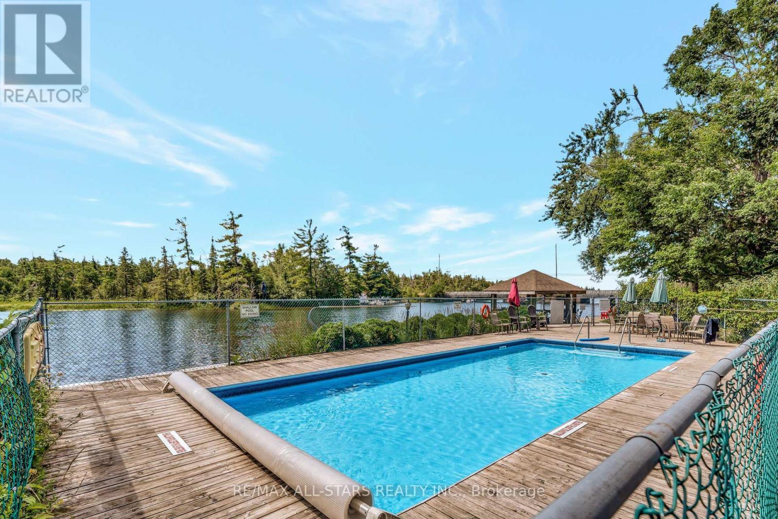 101 - 200 East Street S, Kawartha Lakes (Bobcaygeon), ON - Outdoor With Body Of Water With In Ground Pool With Deck Patio Veranda With Backyard