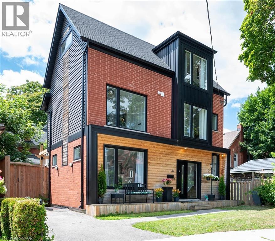 Rear view of house with board and batten siding, brick siding, and a shingled roof - 47 Gruhn Street, Kitchener, ON - Outdoor