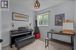 Living area with baseboards and wood finished floors -