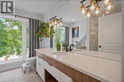 Bathroom featuring a chandelier, vanity, and wood finished floors -