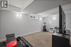 Workout room featuring carpet flooring and a textured ceiling -